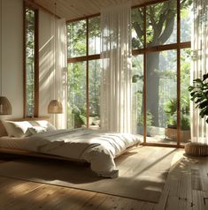 a large bed sitting inside of a bedroom on top of a hard wood floor next to tall windows