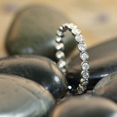 a diamond ring sitting on top of some rocks