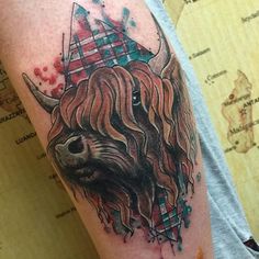 a man with a tattoo on his arm has a buffalo head in the middle of it