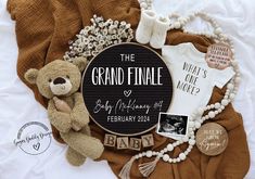 a teddy bear and other baby items are on a blanket with the words, we're expecting