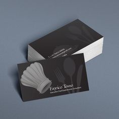 two black and white business cards with forks and spoons on them, sitting side by side