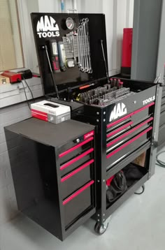 a toolbox with tools in it sitting on top of a workbench,