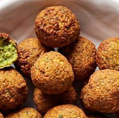 a white bowl filled with meatballs and guacamole