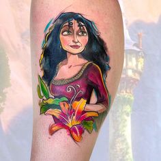 a woman's leg with a flower tattoo on it