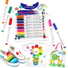 children's art supplies including markers, pens and t - shirt on a white background