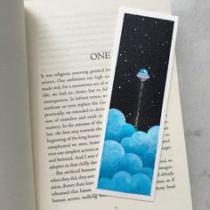 an open book with a photo of a flying object in the sky and on top of it