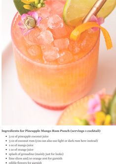 an orange drink is garnished with flowers and limes