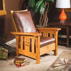 a wooden chair sitting next to a table with a lamp on top of it