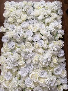 white flowers are arranged in the shape of a wall