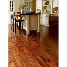 a kitchen with hardwood floors and white cabinets