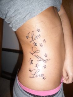 the back of a woman's stomach with stars on it and words written in cursive writing