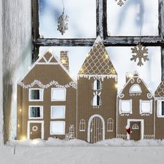 a window sill decorated with gingerbread houses and snowflakes