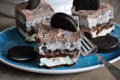 oreo ice cream cake on a blue plate with an oreo cookie and fork