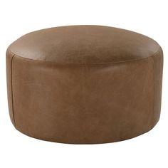 a brown leather ottoman sitting on top of a white floor