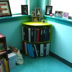 there is a bookshelf in the corner of this room with many books on it