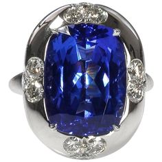 A martini, a Manhattan or a Moscow mule- whichever your favorite cocktail- deserves a matching cocktail ring and this is the one! The deep, velvety blue, oval tanzanite is set in a bold, platinum, bombé mounting with three round diamonds on each of the four sides. Over time, and while being thoroughly enjoyed, the platinum will develop a distinctive patina which is one of the unique characteristics of this noble metal. Make this your signature ring for a fun night out or an elegant event- it kno Stone Ring Design, Signature Ring, Sapphire Cocktail Ring, Tiaras Jewellery, Signature Rings, Tanzanite Diamond Ring, Platinum Earrings, Tanzanite Diamond, Platinum Diamond Rings