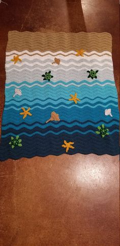 a crocheted rug with sea animals on it