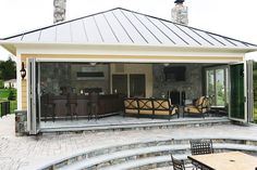 an outdoor living area with patio furniture