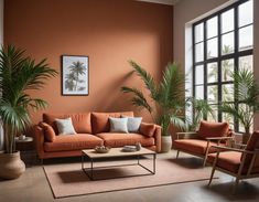 an orange living room with two chairs and a couch in front of a large window