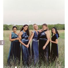 a group of women standing next to each other in a field