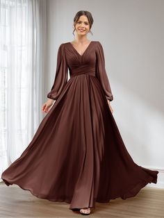 a woman wearing a long brown dress