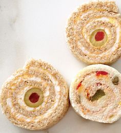 three pastries with different toppings on them sitting on a white counter top next to each other