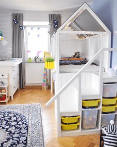 a room with some shelves and bins in it