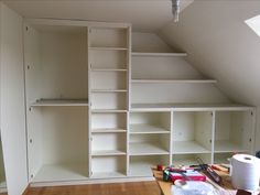 an empty room with shelves and tools on the floor