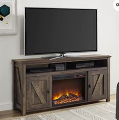 an entertainment center with a fireplace and flat screen tv mounted on it's sides