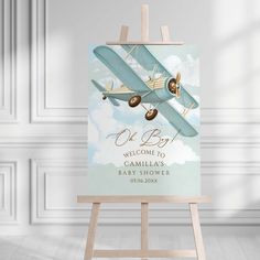 an easel with a welcome sign to a baby boy on it in front of a white wall