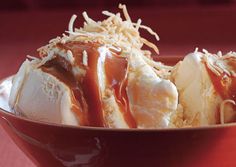 two scoops of ice cream and caramel sauce in a bowl