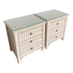 two white wicker dressers with glass tops on each drawer and one is empty