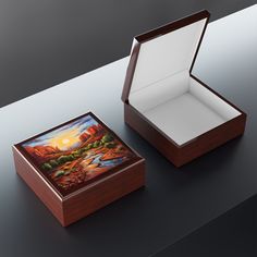 an open box with a painting on the lid and inside sitting on top of a table