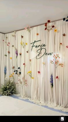 a room with curtains and flowers on the wall