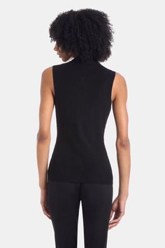 This vest is a year round must. We love layering these under our jackets to create different looks. Model is 5'10.5" and wearing a size smal 83% Viscose, 17% Polyester Machine Wash Cold, Do Not Bleach, Lay Flat To Dry, Cool Iron If Needed, Or Dry Clean Imported Black Fitted Tank Top For Winter, Fitted Black Tank Top For Winter, Fitted Winter Tank Top, Fitted Tank Top For Winter, Stretch Tank Vest For Fall, Black Turtleneck Tank Top For Fall, Fitted Tank Sweater Vest For Fall, Winter Stretch Tank Vest, Fitted Vest For Winter Layering