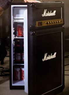 an old fashioned refrigerator with the door open and beer in it's bottom compartment