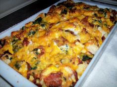 a square casserole dish with cheese and vegetables