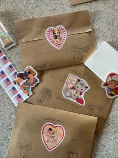 three envelopes with stickers on them sitting on the ground