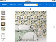 a bed room with a neatly made bed next to a wallpaper store website page