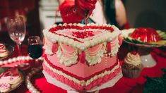 a red and white cake sitting on top of a table