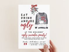 a person holding up a card that says eat drink and be ugly at the nelson's ugly sweater party