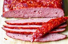 sliced salami on a wooden cutting board