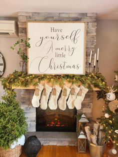 a mantel with stockings and candles on it in front of a sign that says have yourself merry little christmas