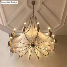 a chandelier hanging from the ceiling in a room with white walls and ceilings