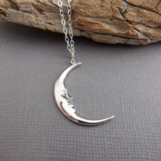 sterling silver smiling crescent moon face necklace, 1 1/8"  - Sterling silver shiny crescent moon with face, 1 1/8" (27 mm) length. - Necklace is 1.5 mm cable chain, length customizable at drop down menu. Lobster clasp and locking circle jump rings, all sterling silver. - Face design is in relief and slightly blackened (oxidized) to bring out the details. Some of the dark reflection in the pictures is my camera. - Shiny finish on front and back, hollowed in back with tiny 925 mark. - Comes wrap Silver Spiritual Moon Charm Necklace, Silver Jewelry With Sun And Moon Design, Silver Personalized Moon Necklaces, Spiritual Silver Moon Charm Necklace, Sterling Silver Moon Charm Necklace For Everyday, Personalized Moon Shaped Silver Necklaces, Nickel Free Half Moon Silver Necklace, Adjustable Silver Half Moon Necklace, Everyday Sterling Silver Charm Necklace With Moon Charm