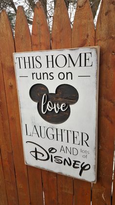 this home runs on love, laughter and lots of disney - themed signs are hung on the fence