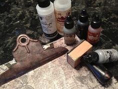 several different types of crafting supplies sitting on top of a piece of paper next to a knife