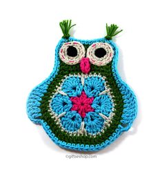 a crocheted owl ornament is shown on a white surface with green and blue trim