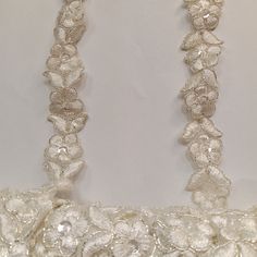 Handmade, high quality Beaded & Corded Lace Trimming Embroidered on 100% Polyester Organza. Beautiful on wedding dresses, evening gowns, dance costumes, quinceanera and more. 100% Polyester / Minimum Order: 1 Yard / Size: Approximately 3/4" Wide / Ships Within 24 Business Hours Available in 18 different colors. White Embellished Embroidered Fabric For Celebrations, Elegant White Beaded Embroidered Fabric, Elegant White Embroidered Beaded Fabric, Elegant Festive Lace With Floral Embroidery, Elegant Floral Embroidered Lace For Festive Occasions, Festive Elegant Lace With Floral Embroidery, Elegant Cream Embroidered Fabric And Notions, Elegant Embroidered Lace Fabric, Elegant Embroidered Trims For Festive Occasions