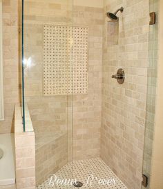 a walk in shower sitting inside of a bathroom